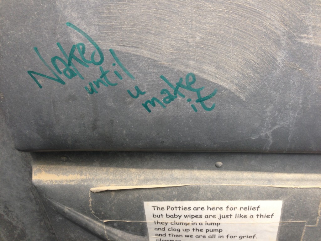 An inspiring message in the portapotty: "Naked until you make it".