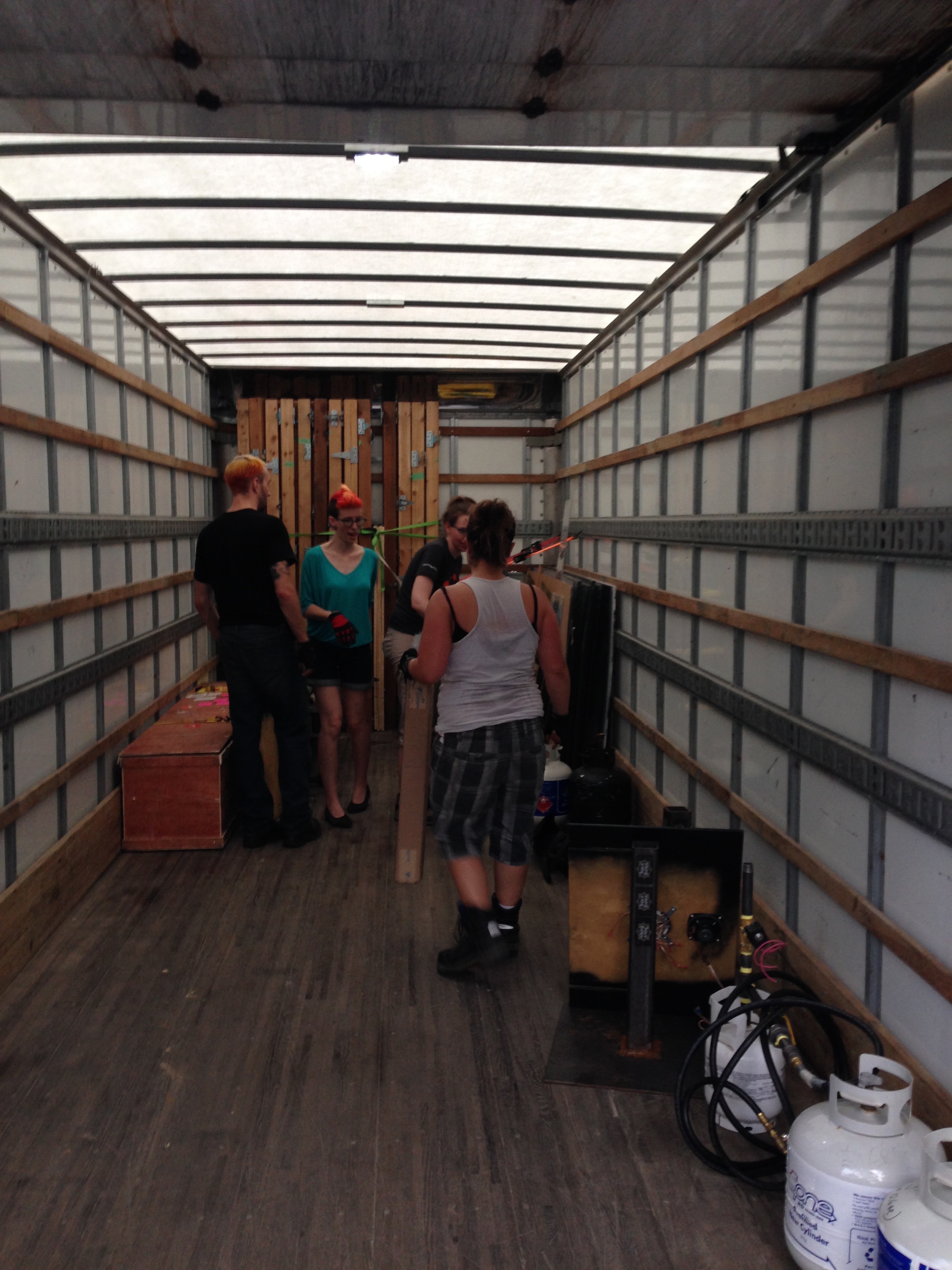 Mike, Sara, Carrie, and Trish have a confab about packing the truck.
