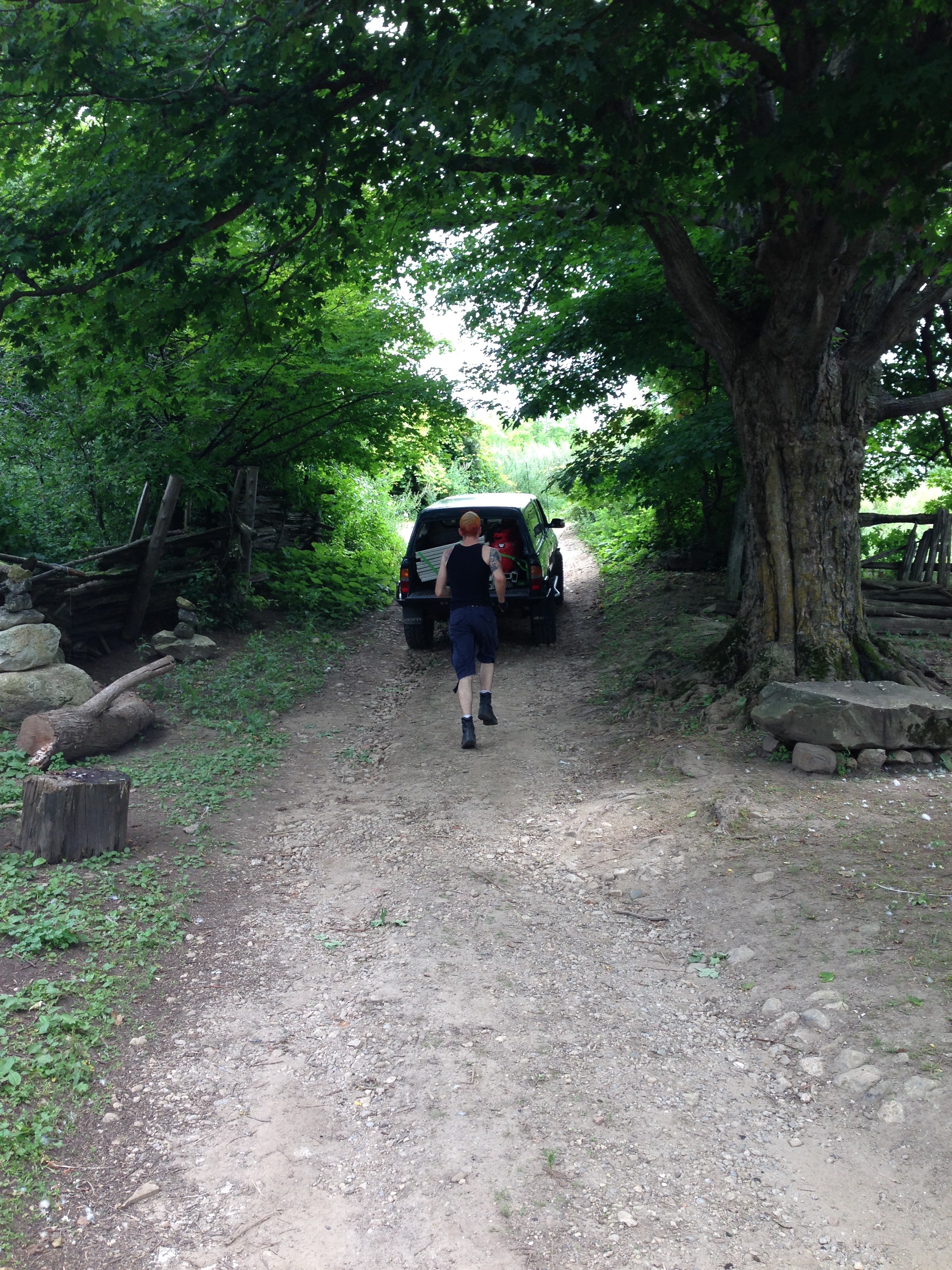 Mike runs after one of the smaller trucks, on the way up the hill to the back field.