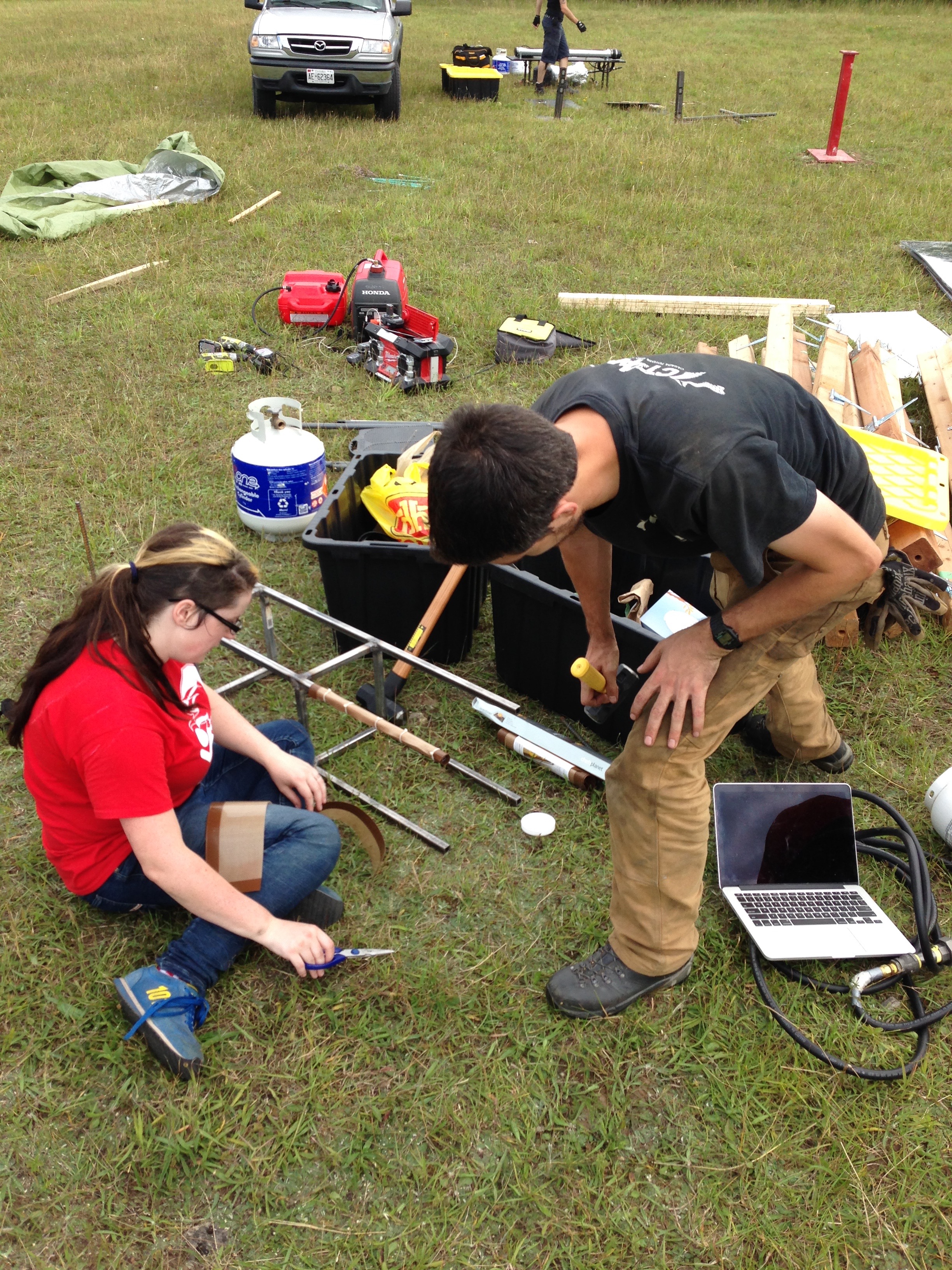 S and Patrick work on affixing the silicone place mats to the quartz tube stand.